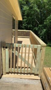 A newly constructed wooden deck featuring a safety gate, built by SMM Services LLC in Gulfport, MS.