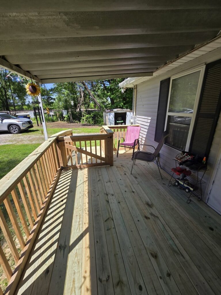 A spacious, newly built wooden deck with railings by Gateway Home Services KC LLC in Kansas City, MO.