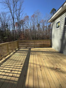 A newly built wooden deck with railings, showcasing quality craftsmanship by River City Builders in Richmond, VA.