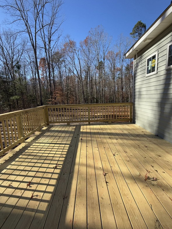 A newly built wooden deck with railings, showcasing quality craftsmanship by River City Builders in Richmond, VA.