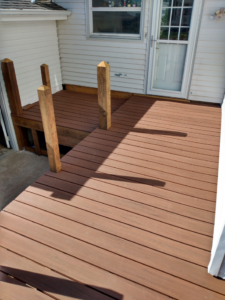 A newly built wooden deck and ramp leading to a house door, completed by RT Handyman LLC in Sioux Falls, SD.