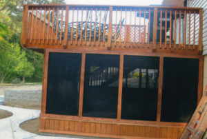 A newly built wooden deck and screened porch by Central Illinois Construction Services Inc. in Effingham, IL
