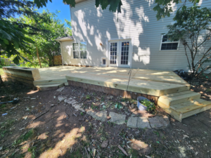 A newly constructed wooden deck attached to a house, built by She Builds Indy GC in Indianapolis, IN.