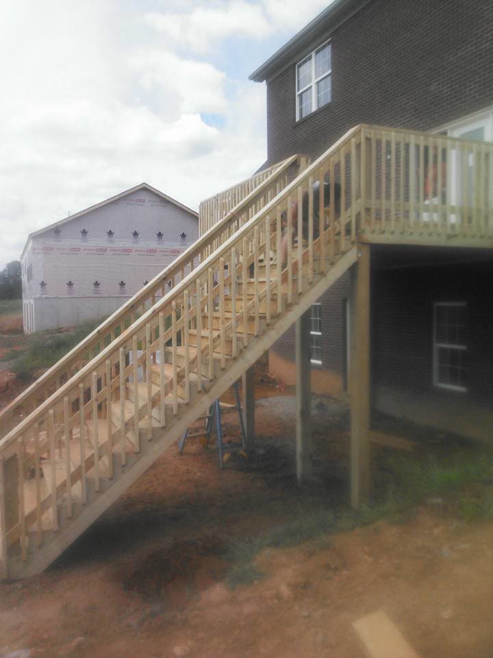 A newly built wooden deck and stairs by Detweiler Construction, LLC for a home in Horse Cave, KY.