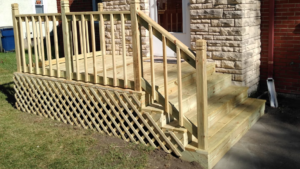 A newly built wooden deck and stairs with lattice skirting, showcasing quality carpentry by Waterloo Handyman in Waterloo, IA.