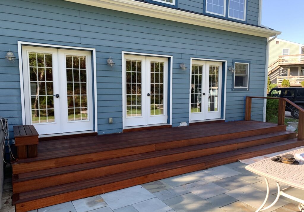 A newly built wooden deck and stone patio by Cappco Pressure Washing in New Rochelle, NY