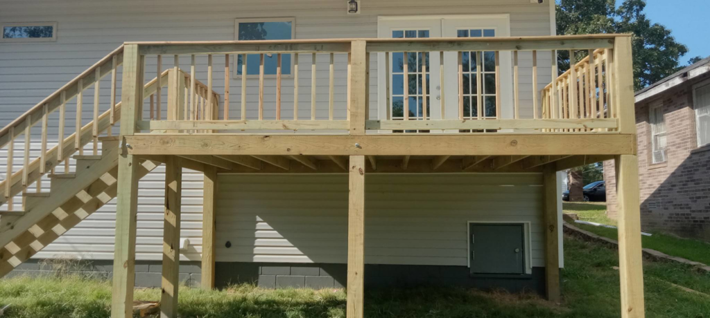 A newly built wooden deck with railings and stairs, showcasing quality construction by Wilcox Handyman Services in Conway, AR.