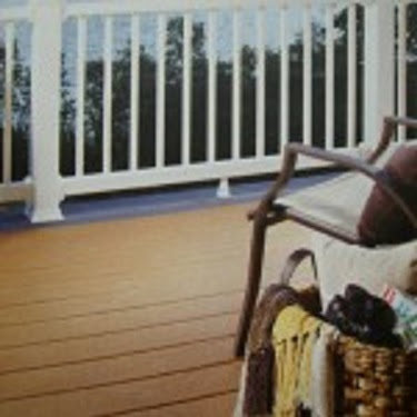 A newly built wooden deck with white railings and outdoor furniture by Pocatello Handyman in Pocatello, ID