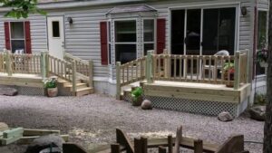 A house featuring two newly built wooden decks with stairs, expertly constructed by The Creative Carpenter in Minot, ND.