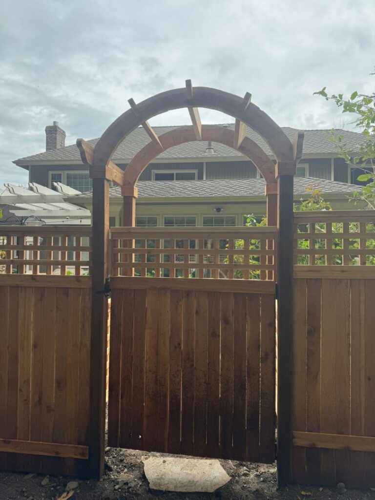 Newly built wooden fence with an arched gate by Prime Construction ent. in Bloomingburg, NY