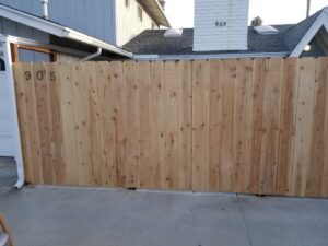 A newly built wooden fence with house numbers "905" installed by ALKA Construction/ Handyman Services in Layton, UT