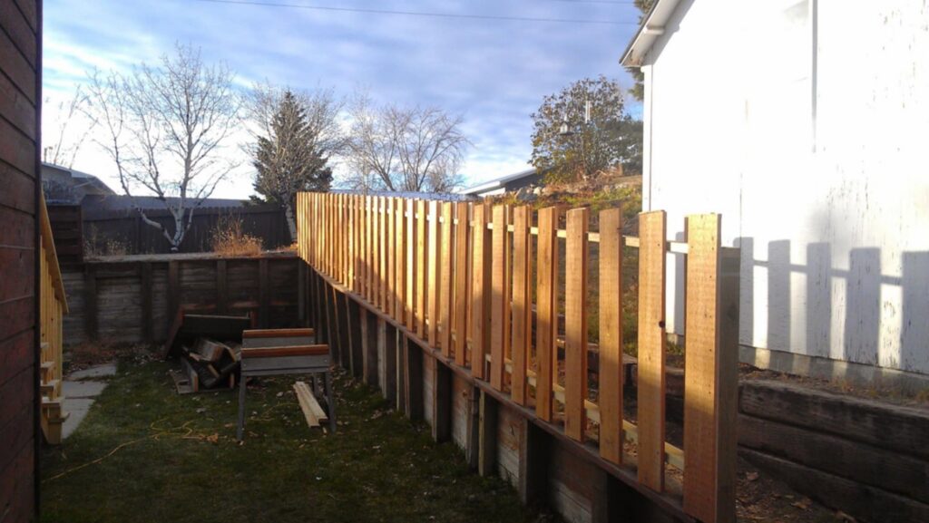 A newly built wooden picket fence, a quality installation by The Creative Carpenter in Minot, ND.