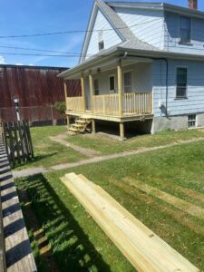 A newly built wooden porch and stairs by Wood Trades LLC in Westport, MA.