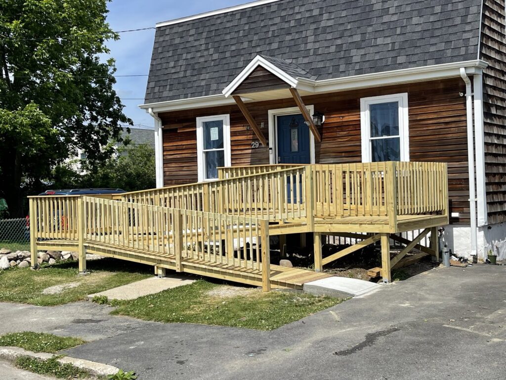 A newly built wooden accessibility ramp and deck by Wood Trades LLC in Westport, MA.