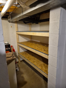 Newly built wooden shelves installed in a basement by All-In-One Contracting and Home Improvement in Canton, OH