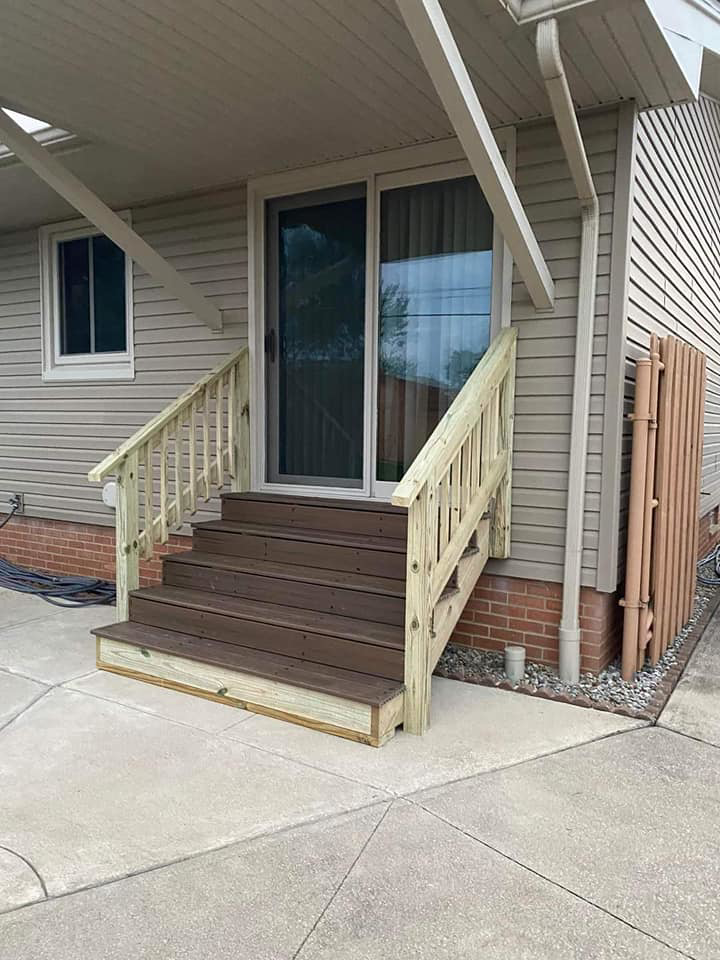 A newly built wooden staircase and railing on a house by Indoor/Outdoor Home Repairs in Parma, OH.