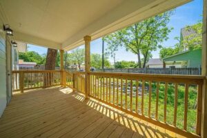 A newly constructed wooden deck with railings, showcasing outdoor living space by Morin Construction LLC in San Antonio, TX