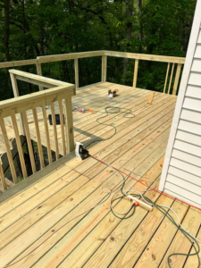 A newly constructed wooden deck with tools and materials, built by Aaron's Handyman Service in Tucson, AZ.