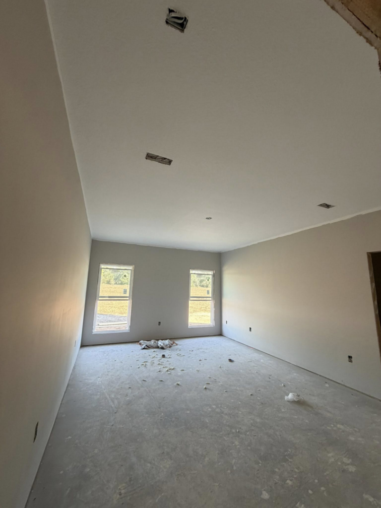 A newly drywalled and painted room interior, showcasing quality finishing by JM Drywall LLC in Dothan, AL.