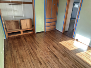 A room showcasing newly finished hardwood floors and freshly painted walls by Valleys Finest Custom Finishes LLC in Salem, OR.