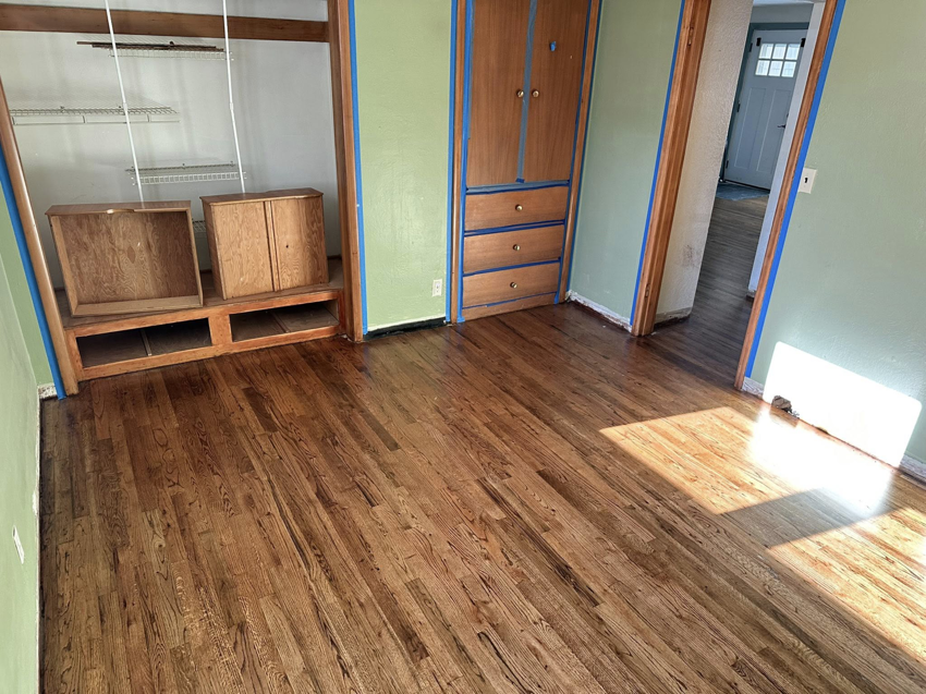 A room showcasing newly finished hardwood floors and freshly painted walls by Valleys Finest Custom Finishes LLC in Salem, OR.