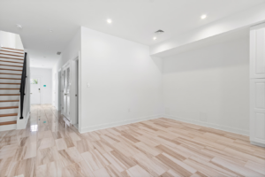 A newly finished interior living space with light wood-look tile flooring by EK Construction, LLC in Philadelphia, PA