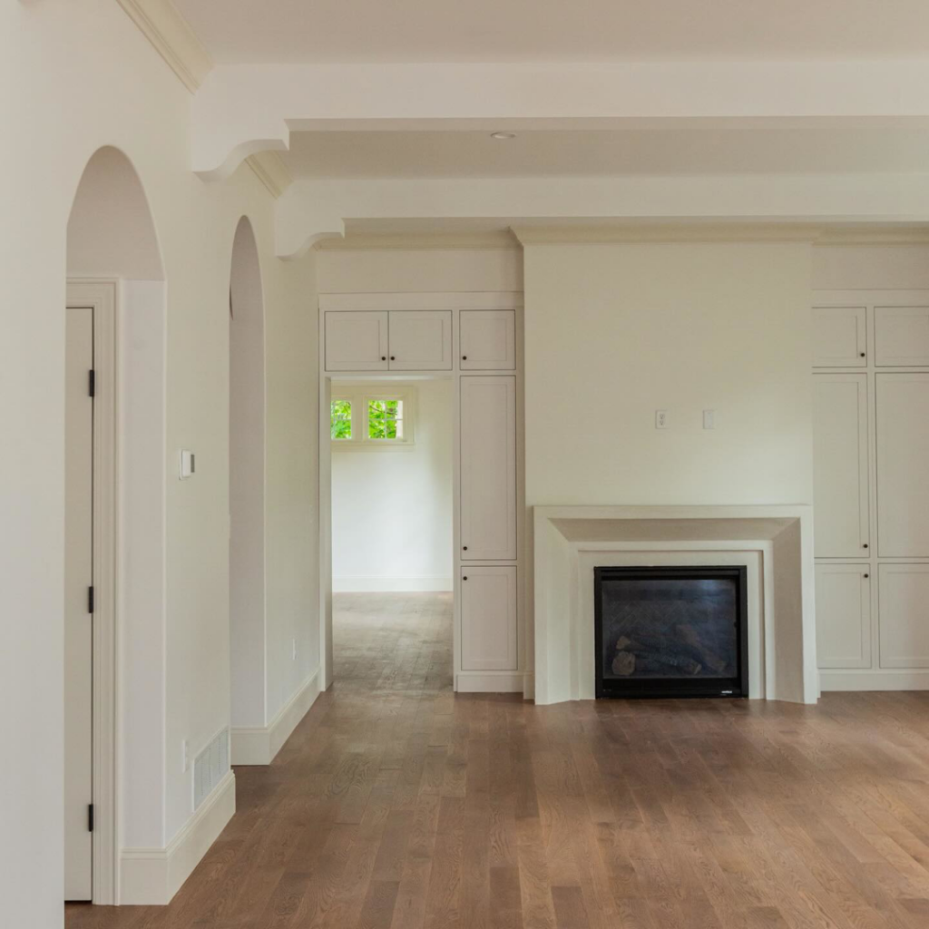A newly finished living room with hardwood floors, built-in cabinets, and a modern fireplace by Brentwood Builders Inc. in Lancaster, PA.