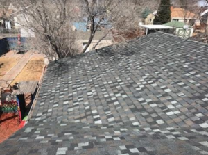 An aerial view of a newly installed or repaired asphalt shingle roof, completed by Rick's Handyman in Cheyenne, WY.