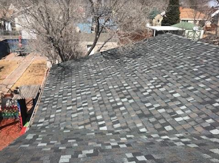 An aerial view of a newly installed or repaired asphalt shingle roof, completed by Rick's Handyman in Cheyenne, WY.