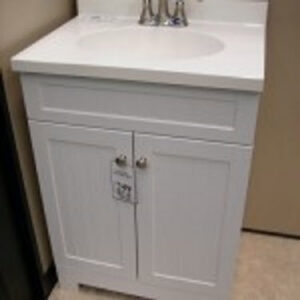 A newly installed white bathroom vanity with a sink and faucet by Pocatello Handyman in Pocatello, ID