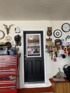 A newly installed black garage entry door, a handyman service provided by Urban Exteriors in Green Bay, WI.