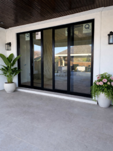 Newly installed black multi-panel glass patio doors completed by JPS Home Builders LLC in Kenner, LA.