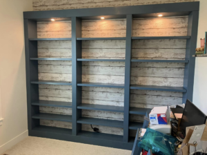 Newly installed custom built-in bookshelves with recessed lighting by IGM Handyman Services in Meridian, ID.