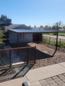 Newly installed metal carport and brown fence by Able Fence LLC in Tucson, AZ.