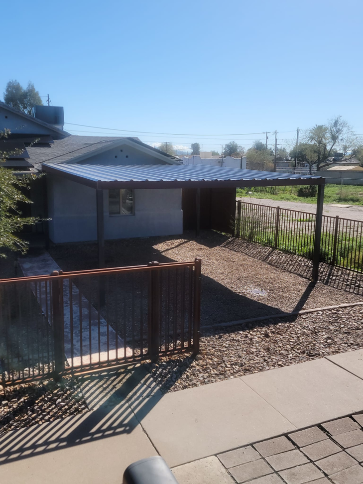Newly installed metal carport and brown fence by Able Fence LLC in Tucson, AZ.
