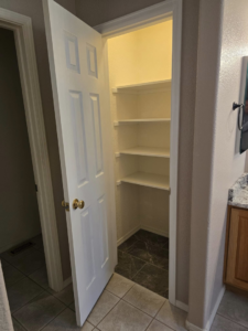 Newly installed white shelving in a closet or pantry by Next Level Finish, providing organization solutions in Fort Collins, CO.