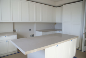 Newly installed light-colored countertops in a white kitchen or laundry room by L&M Granite Countertops in Phoenix, AZ.