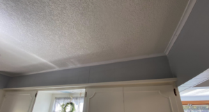 Newly installed white crown molding along a kitchen ceiling by Blackbird Custom Carpentry in Kansas City, MO.