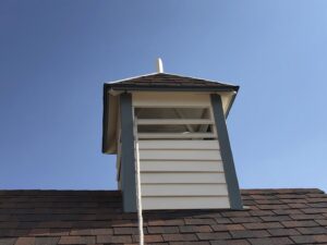 A newly installed or restored cupola on a shingled roof by Deep Roots Craftsmen in Fort Collins, CO.