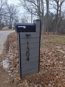 A newly installed custom mailbox post with house numbers by American Renovation Llc in Fairplay, SC.