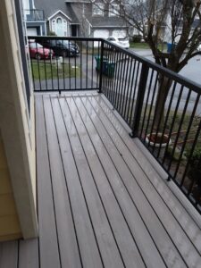 A newly installed outdoor deck or balcony with modern black railings by Guzmanremodeling LlC in Renton, WA.