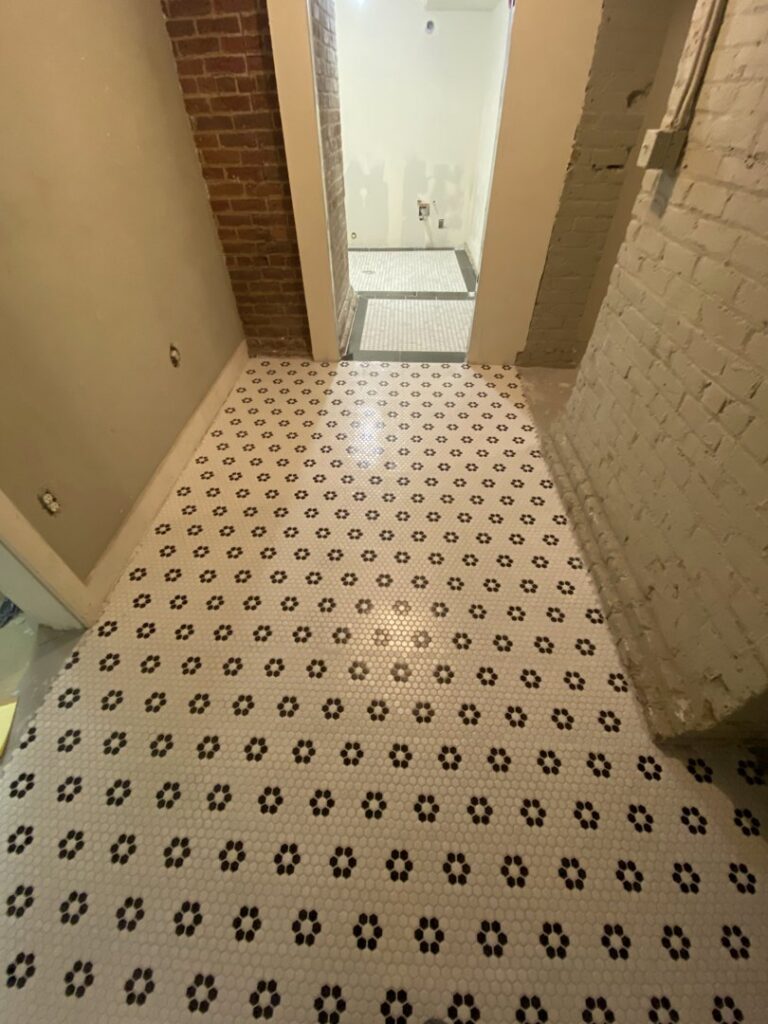 A newly installed decorative tile floor, a completed project by Infinite Creations Construction, LLC in Denver, CO