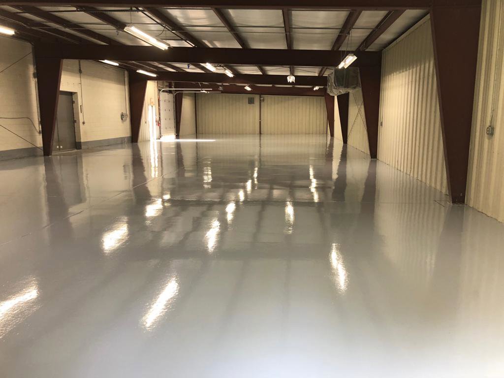 A newly installed, shiny epoxy floor in a commercial space by Alpine Painting and Sandblasting Contractors in Paterson, NJ.