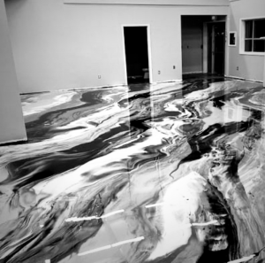 Newly installed black and white marbled epoxy floor in a large commercial space by Lex Floors in Miami, FL.