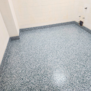 A newly installed speckled epoxy floor in a utility room by Lifetime Epoxy Floors North Alabama in Boaz, AL.