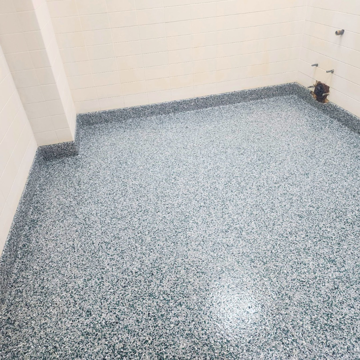 A newly installed speckled epoxy floor in a utility room by Lifetime Epoxy Floors North Alabama in Boaz, AL.