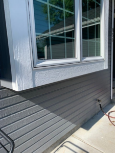 Newly installed exterior siding and window trim by Simmons Handyman Services & Contracting LLC in Billings, MT
