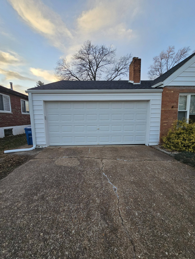 A newly installed garage door and renovated exterior by AIS Home Service's in St. Louis, MO.