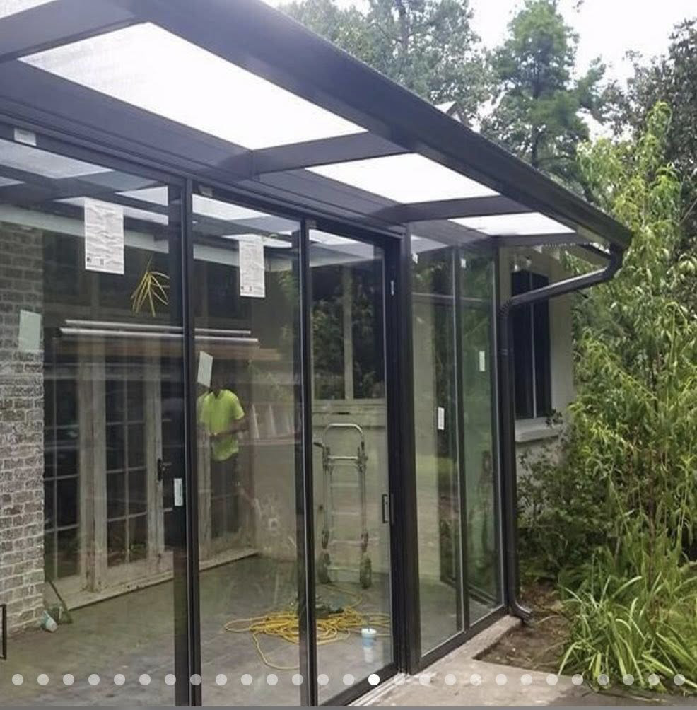 A newly installed glass sunroom or patio enclosure attached to a brick house by Cover Works in Luling, LA.