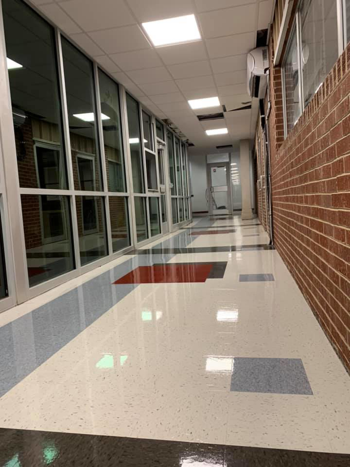 Newly installed, multi-colored tile flooring in a long hallway, a service provided by Aggregate in Enid, OK